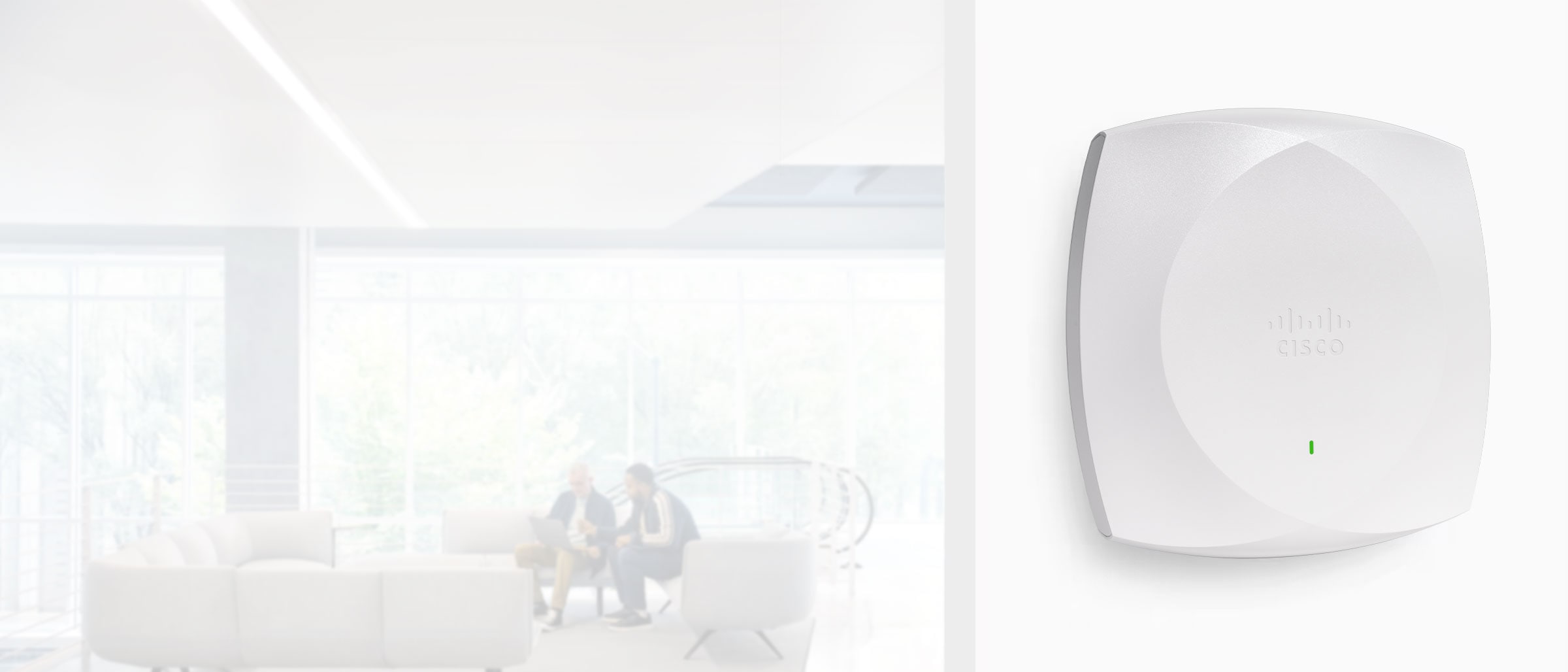 Close up of a CW Model Family Meraki Access Point with people in the background.
