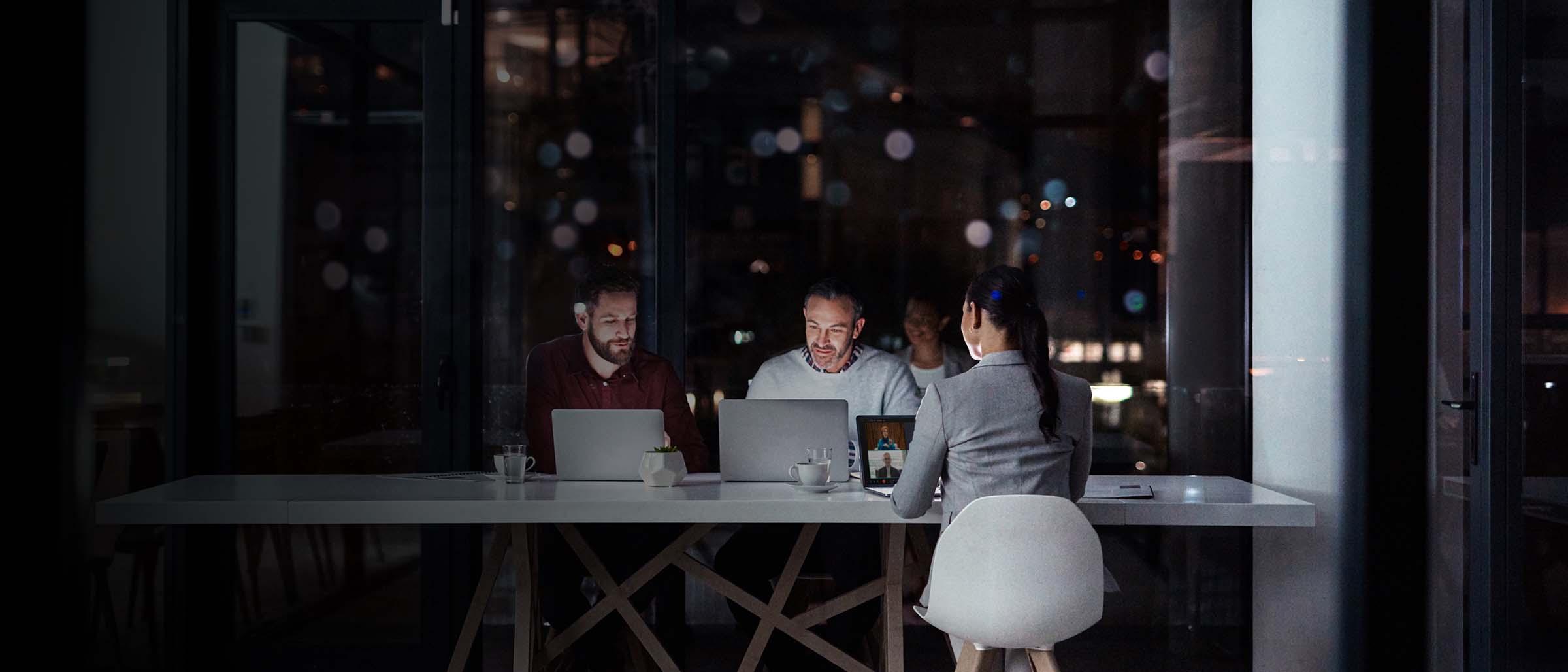 Team collaboration in modern office at night