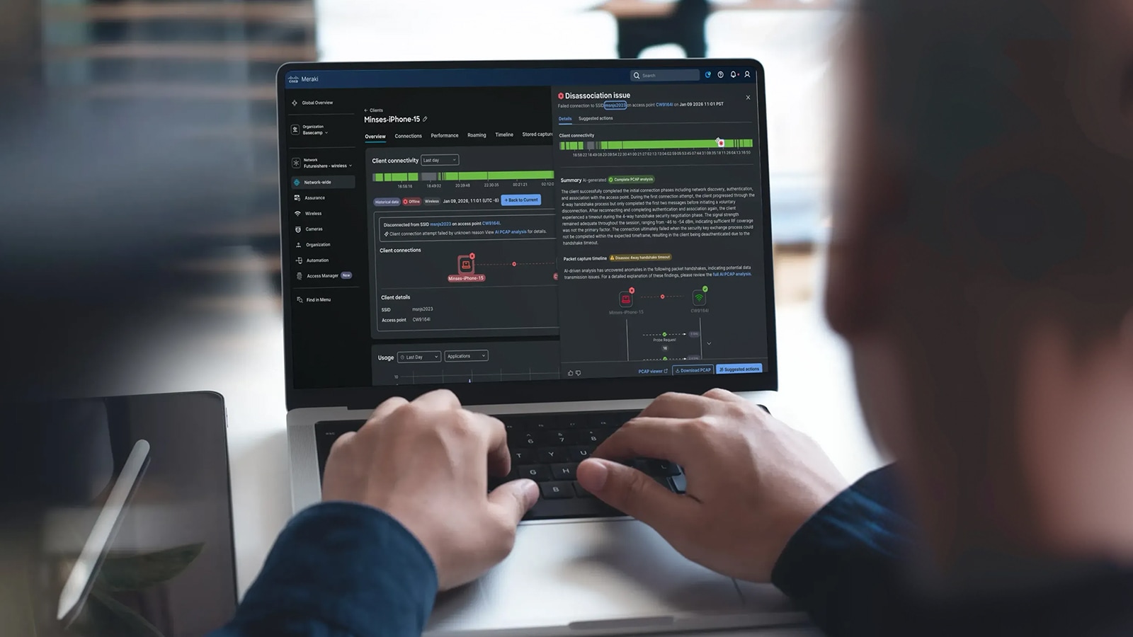 Laptop screen with Meraki dashboard showing a global overview dashboard with details about a "Disassociation issue.”